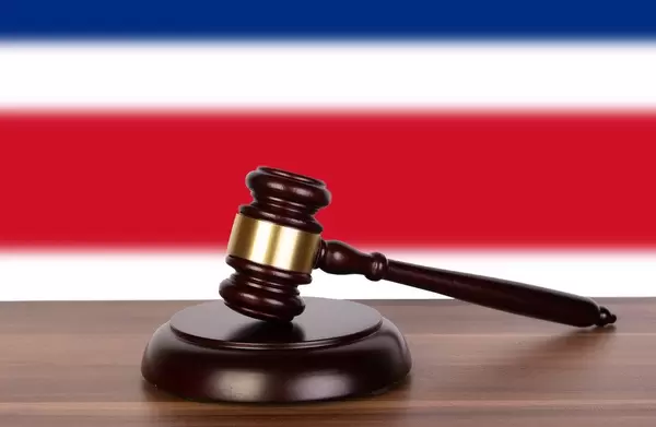 Wooden gavel and flag of Costa Rica