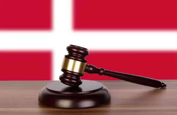 Wooden gavel and flag of Denmark