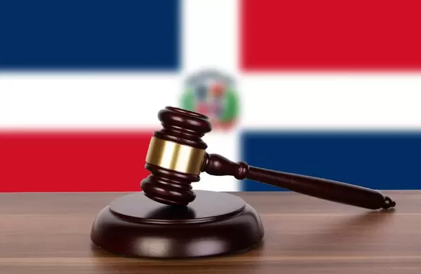 Wooden gavel and flag of Dominican Republic