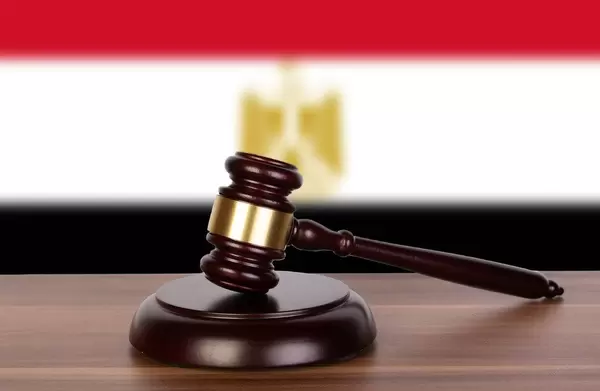 Wooden gavel and flag of Egypt