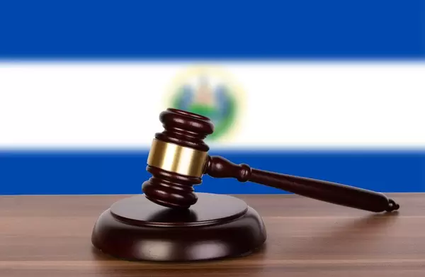 Wooden gavel and flag of El Salvador