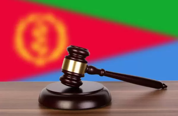 Wooden gavel and flag of Eritrea