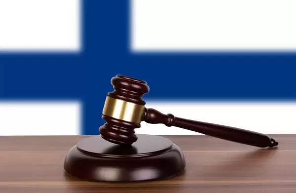 Wooden gavel and flag of Finland