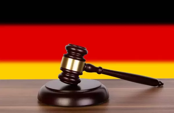 Wooden gavel and flag of Germany