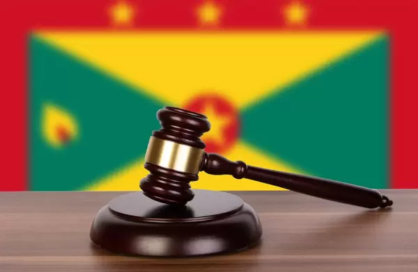 Wooden gavel and flag of Grenada