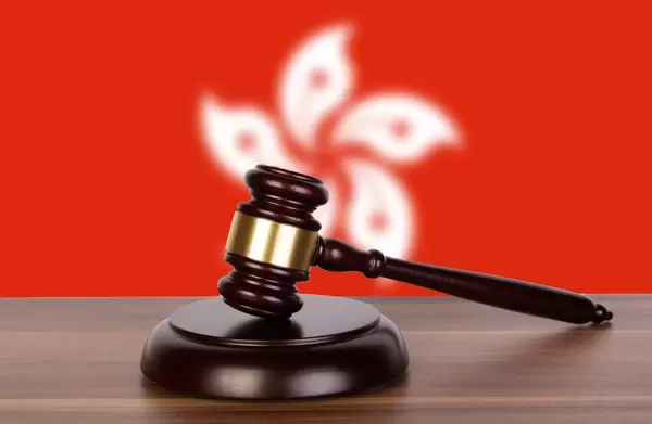 Wooden gavel and flag of Hong Kong