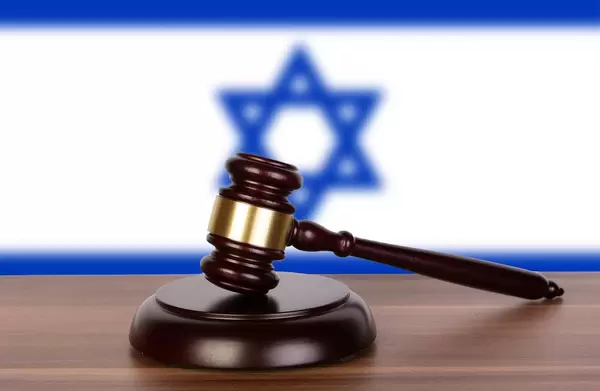 Wooden gavel and flag of Israel