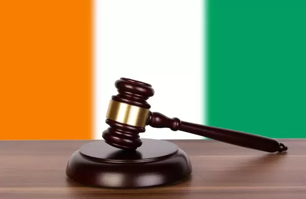 Wooden gavel and flag of Ivory Coast