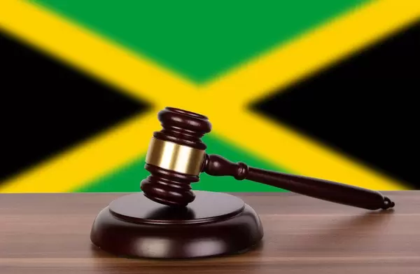 Wooden gavel and flag of Jamaica