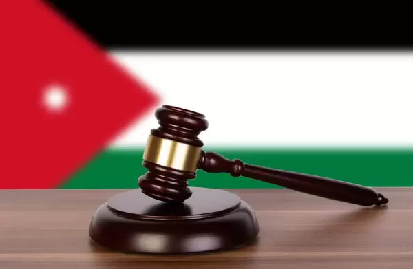Wooden gavel and flag of Jordan