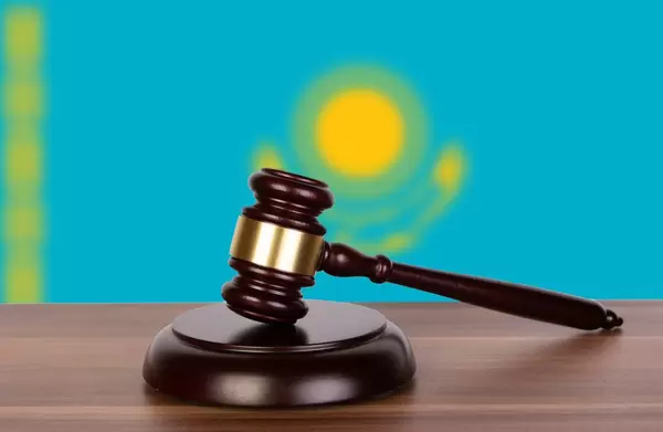 Wooden gavel and flag of Kazakhstan