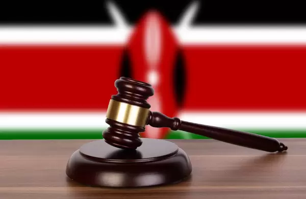 Wooden gavel and flag of Kenya
