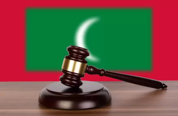Wooden gavel and flag of Maldives
