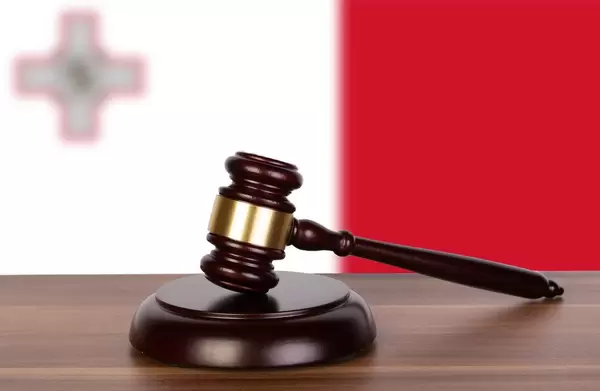 Wooden gavel and flag of Malta