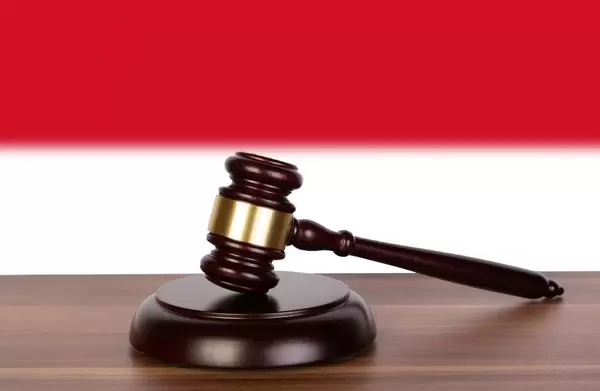 Wooden gavel and flag of Monaco