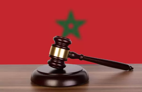 Wooden gavel and flag of Morocco