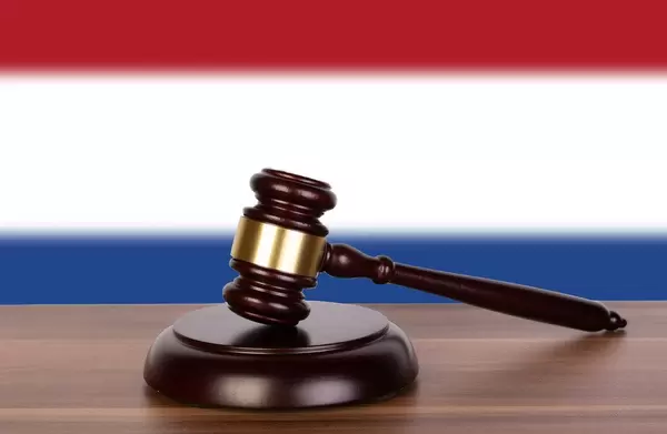 Wooden gavel and flag of Netherlands