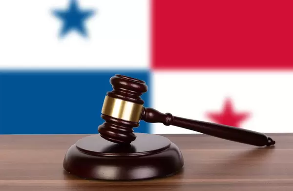 Wooden gavel and flag of Panama