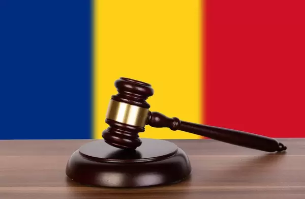 Wooden gavel and flag of Romania