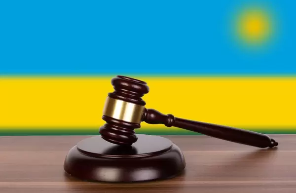 Wooden gavel and flag of Rwanda