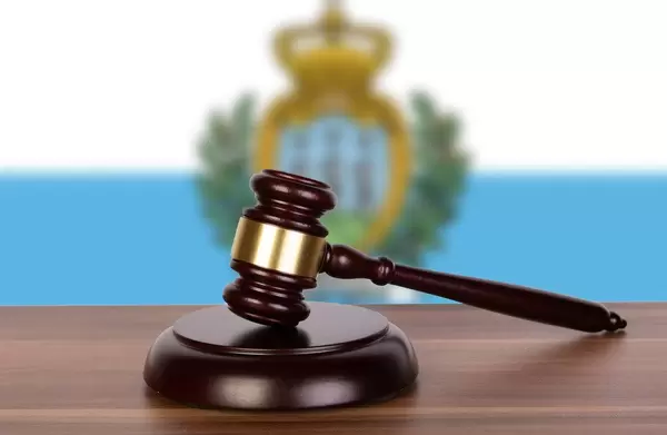 Wooden gavel and flag of San Marino