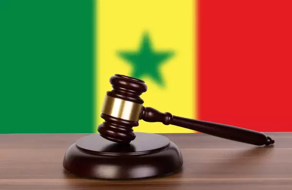 Wooden gavel and flag of Senegal