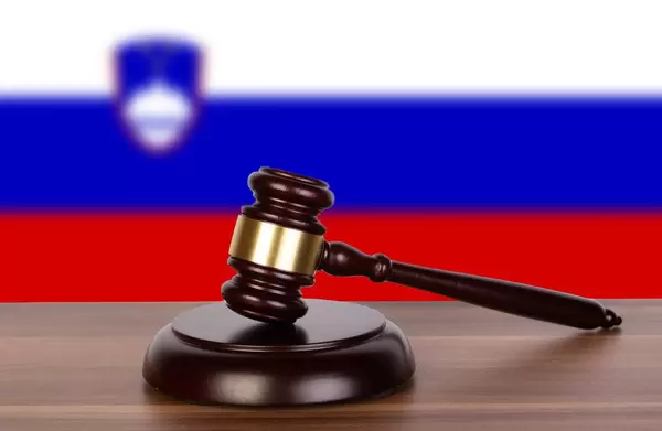 Wooden gavel and flag of Slovenia