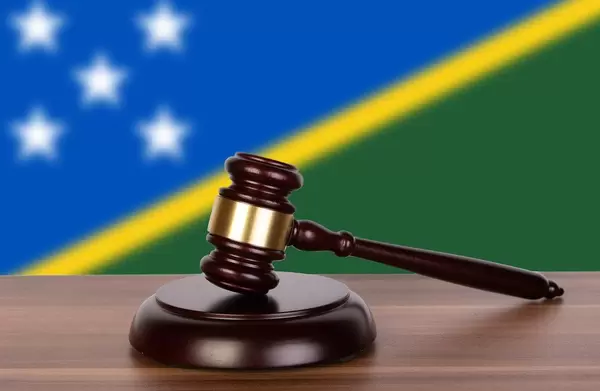 Wooden gavel and flag of Solomon Islands