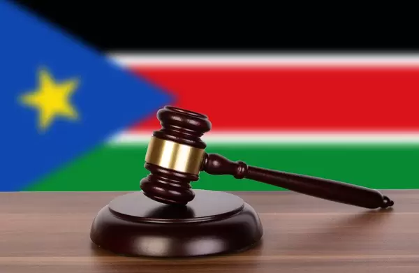 Wooden gavel and flag of South Sudan