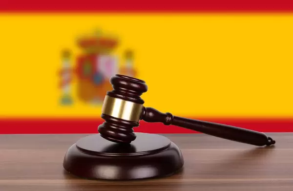Wooden gavel and flag of Spain