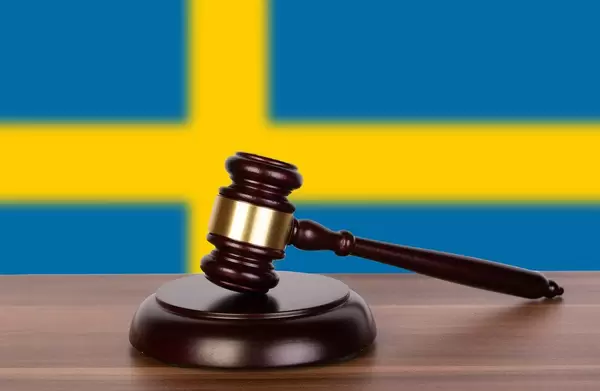 Wooden gavel and flag of Sweden