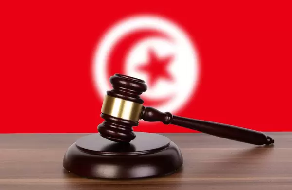 Wooden gavel and flag of Tunisia