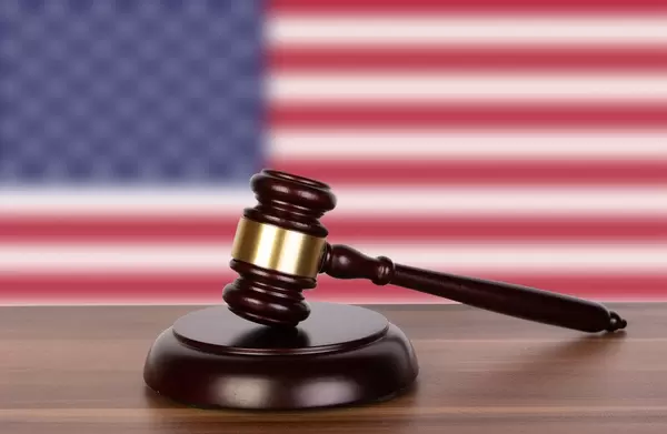 Wooden gavel and flag of United States of America
