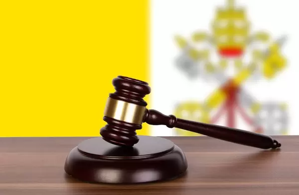 Wooden gavel and flag of Vatican City