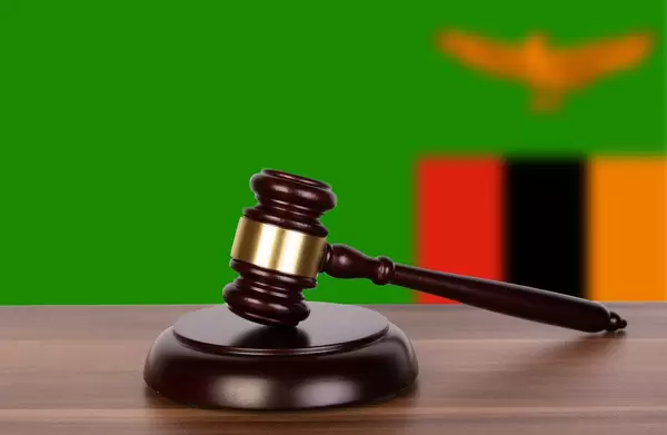 Wooden gavel and flag of Zambia