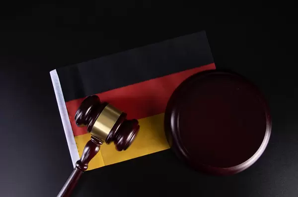 Wooden judge gavel and flag of Germany
