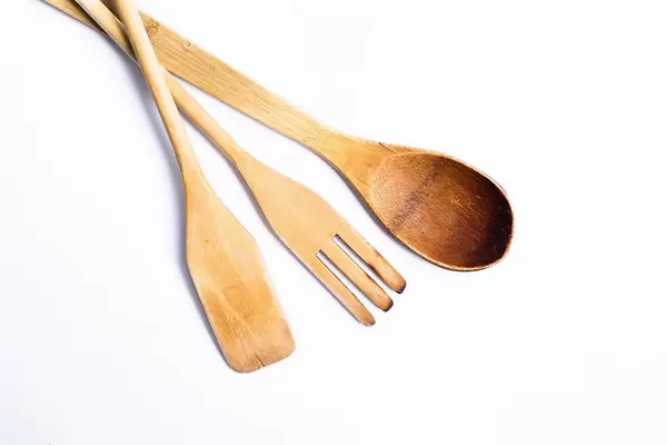 Wooden kitchen utensils - spoon, spatula on white background.jpg