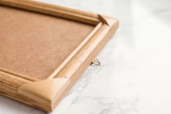 Wooden photo frame on marble background. Close up.