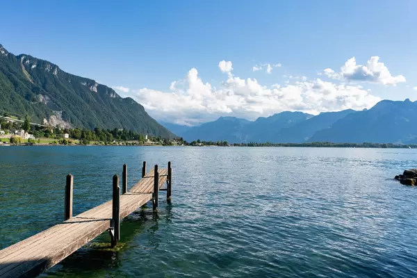 Wooden pier on beautiful lake Geneva next to the Chillon castle