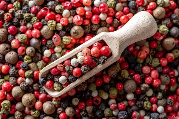 Wooden scoop with a mixture of peppers
