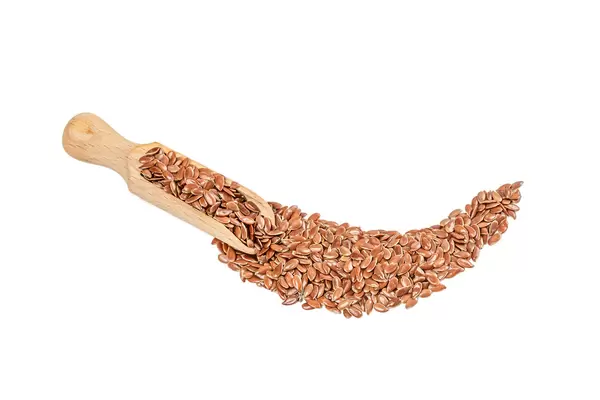 Wooden scoop with flax seeds on white
