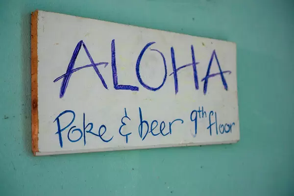 Wooden Sign Board of Aloha Poke & Beer Restaurant and Bar in Ho Chi Minh City, Vietnam