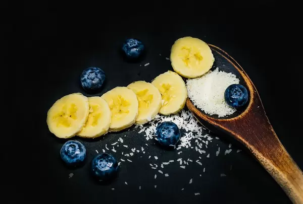 Wooden Spoon with Coconut, Banana Slices and Blueberries