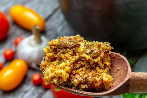 Wooden spoon with pilaf and meat close-up (Flip 2019)