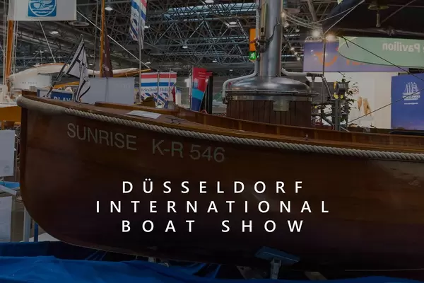 Wooden steam boat Surnise K-R 546, exhibited at a fair in Germany, next to the title "Düsseldorf International Boat Show"