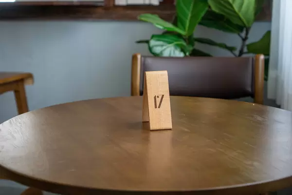 Wooden Table Number to Receive an Order on a Wooden Round Table in a Cafe