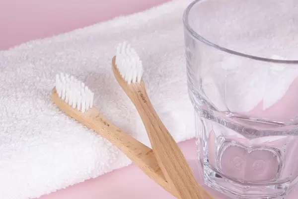 Wooden toothbrushes with glass and towel