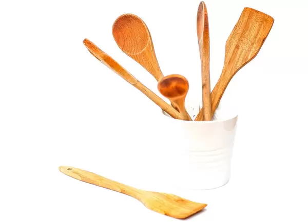 Wooden Ustencil in a Bowl on a White Background