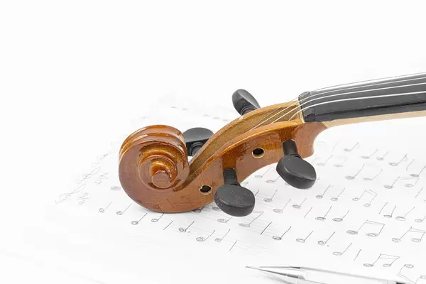 Wooden Violin Scroll with Notes on the sheet music