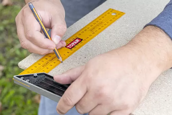 Woodworker taking measures for cutting wood